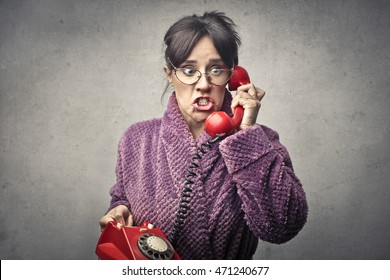 Worried woman in bathrobe doing a phone call