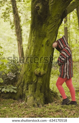 Worried woman in green forest