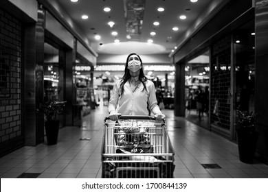 Worried Woman With Mask Groceries Shopping In Supermarket,pushing Trolley.Food Panic Buying And Hoarding.Covid-19 Quarantine Shopper.Financial Problems Anxiety.Unemployed Person In Money Crisis