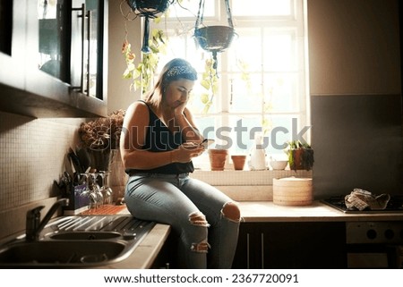 Worried woman reading fake news on phone, searching social media or receiving bad news on technology during lockdown. Browsing or texting while looking stressed, concerned and anxious in home kitchen