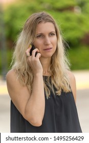 Worried woman receiving bad news over the phone