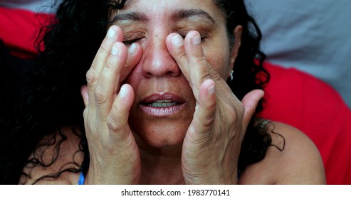Worried Woman Rubbing Face With Hands Feeling Stress. Hispanic Latina Woman In 40s