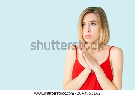 Worried woman. Unexpected problem. Nervous situation. Panic emotion. Pretty scared lady feeling disturb isolated blue copy space.