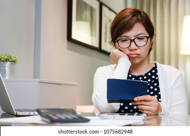 Worried Young Asian Woman Calculating Her Monthly Expenses. Stressed Female Thinking Something At Her House. Financial Crisis Problem Concept