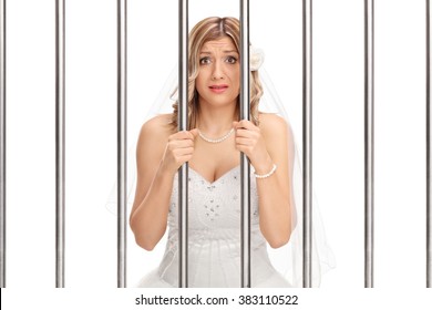 Worried Young Bride Standing Behind Bars In Jail Isolated On White Background