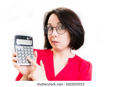 Worried young businesswoman holding a calculator