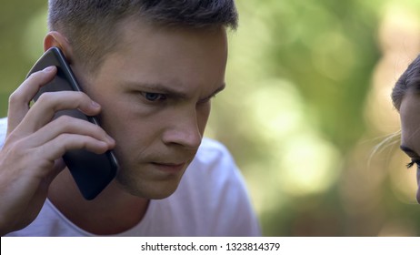 Worried Young Man Calling 911 To Report Crime Or Ask For Medical Help, Closeup