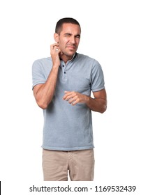 Worried Young Man Doing An Itching Gesture