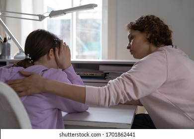 Worried Young Mother Talking Comforting Upset Teen Daughter Helping With Problem Or Apologizing At Home. Caring Parent Mum Consoling Depressed Adolescent Child Giving Psychological Support Concept.