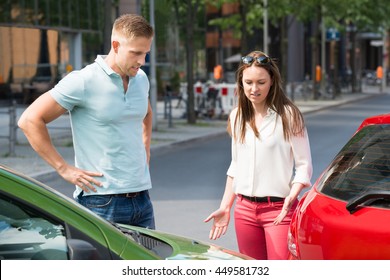 Worried Young People Looking At Car Collision