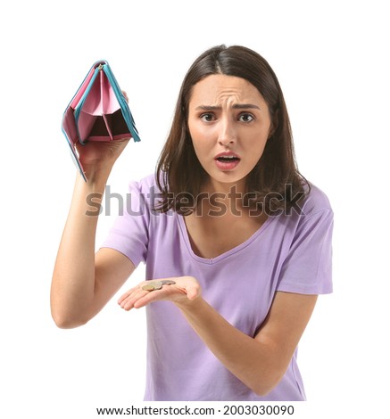 Worried young woman with empty wallet on white background