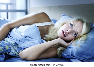 Worried Young Woman Laying In Bed Sleepless At Night