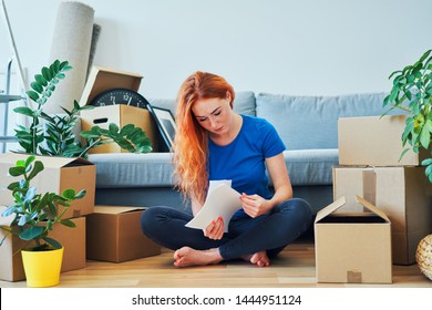 Worried Young Woman Looking Through Apartment Rent Agreement