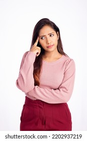 Worried young woman thinking on white background. - Shutterstock ID 2202937219