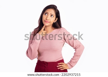 Worried young woman thinking on white background.