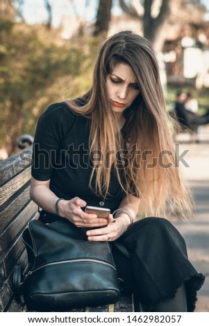 Similar – Image, Stock Photo Blonde woman looking at her smartphone outdoors