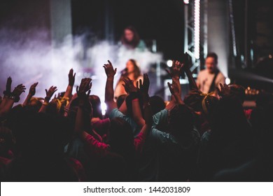 Worship Background With Hands Raised In The Crowd