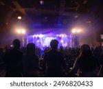 Worship includes music and numerous people  to God on stage
