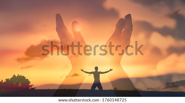 Worshiping hands raised up with open palms to the sunset\
sky.  Christian Religion concept background. Faith, hope, and\
prayer concept. 