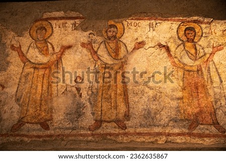 Worshipping saints, secco wall painting from Caesarea Maritima, 6th-7th century CE (Byzantine period), Israel. Pigment on plaste. Greek initials above. Trees.
