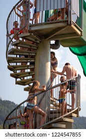 WORTHERSEE, AUSTRIA - AUGUST 07, 2018:  People Climbing The Ladder To The Water Park Slide Start.