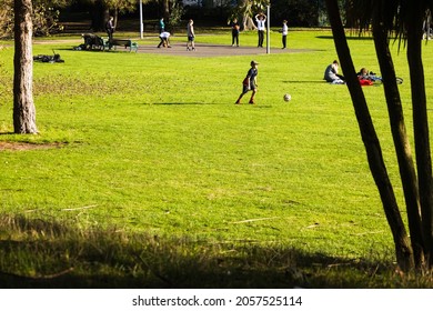 Worthing, UK. October 11 2021. Young People Playing In The Local Park After School As Sunset Approaches. Note The Fallen Leaves From A Recent Storm, Which Keeps The Grass Green.