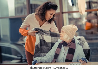 Would You Like Anything. Pleasant Kind Woman Talking To Her Guest While Taking Care Of Her