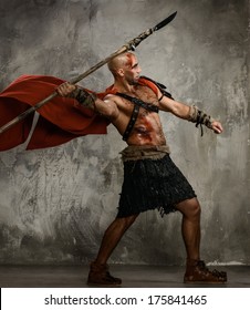 Wounded Gladiator In Red Coat Throwing Spear