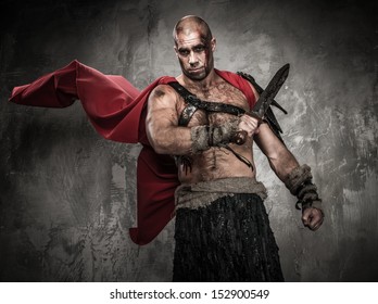 Wounded gladiator with sword covered in blood - Shutterstock ID 152900549