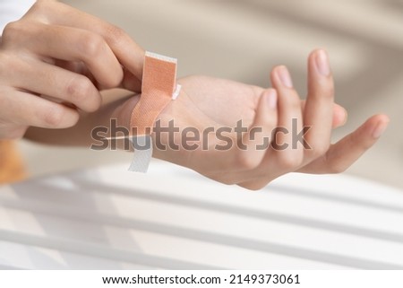 Wounded hand of woman, first aid treated with elastic bandage, closeup shot