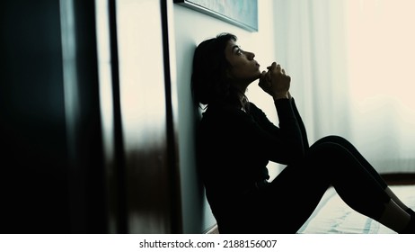 Wounded Person Sitting On Floor Praying For Help. One Hispanic Girl Prays To God Seeking Guidance