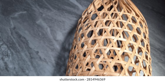 Woven Bamboo Basketwork with Hexagonal Pattern on Dark Marble Background