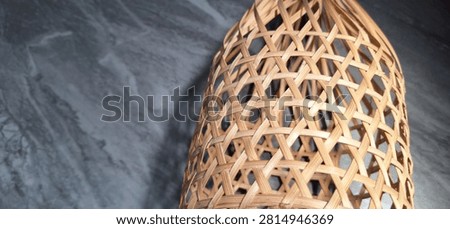 Woven Bamboo Basketwork with Hexagonal Pattern on Dark Marble Background
