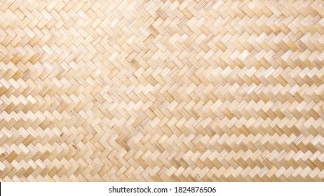 Woven bamboo wall Thai style pattern nature texture background.
Basketry bamboo mat seamless pattern.
 top view.