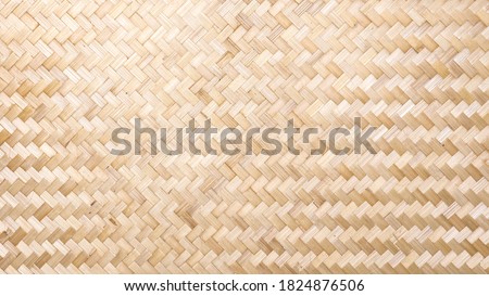 Woven bamboo wall Thai style pattern nature texture background.
Basketry bamboo mat seamless pattern.
 top view.
