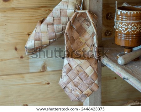 Woven bast shoes made of birch bark. Rustic shoes that people used to wear in the past. The traditions of making shoes in the village.