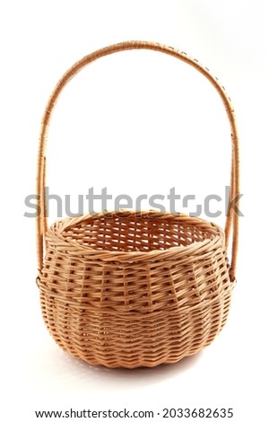 Woven empty sallow wicker basket isolated on a white background