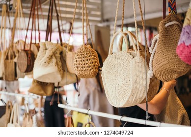 Woven Handbags Hanging In Outdoor Store