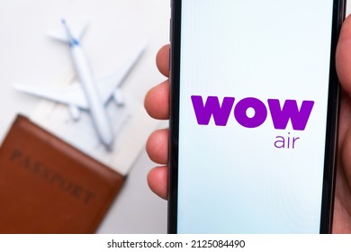 WOW Air Airline App On A Smartphone Screen With A Plane And Passport On The Background. The Concept Of Travel App. November 2021, San Francisco, USA