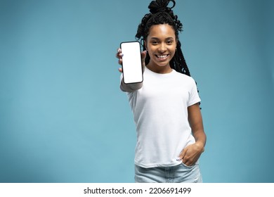 Wow, Amazing Useful App. Portrait of excited and surprised young woman holding smartphone with white blank screen in hand, showing device, closeup. Gadget with empty free space for mock up template