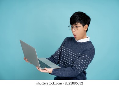 Wow, Asian Businessman Shocked And Holding A Laptop Computer In The Studio.