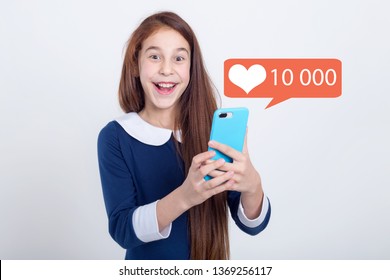 Wow! Beautiful girl with smart phone got processed from ten thousand likes. She is very happy and delighted. Social media - concept. - Shutterstock ID 1369256117