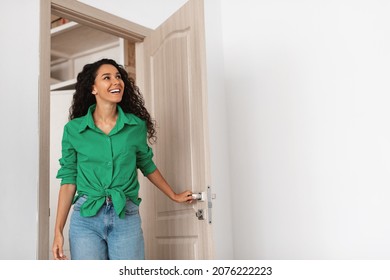 Wow. Cheerful lady walking in modern flat, entering new home, happy young female standing in doorway of apartment, holding doorknob handle looking at design interior, coming inside, free copy space - Powered by Shutterstock