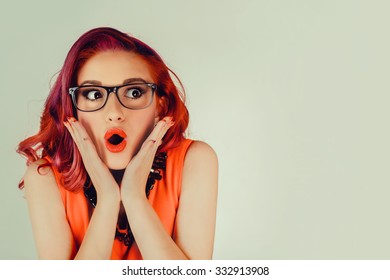 Wow. Close up portrait young woman beautiful girl with long red hair looking excited holding her mouth opened, hands on head, isolated green wall. Shocked surprised stunned. Positive human emotion