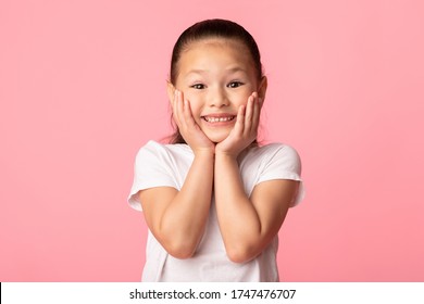 Wow. Closeup Portrait Of Excited Asian Child Touching Her Cheeks, Isolated Over Pastel Purple Studio Wall, Copyspace