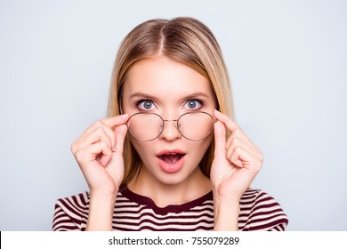 Wow! I Don't Believe You! Close Up Portrait Of Shocked Astonished Woman With Open Mouth And Big Eyes, She Is Touching Her Spectacles