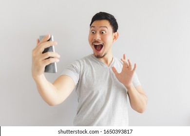 Wow Face Of Asian Man In Grey T-shirt Get Surprised On The Smartphone.