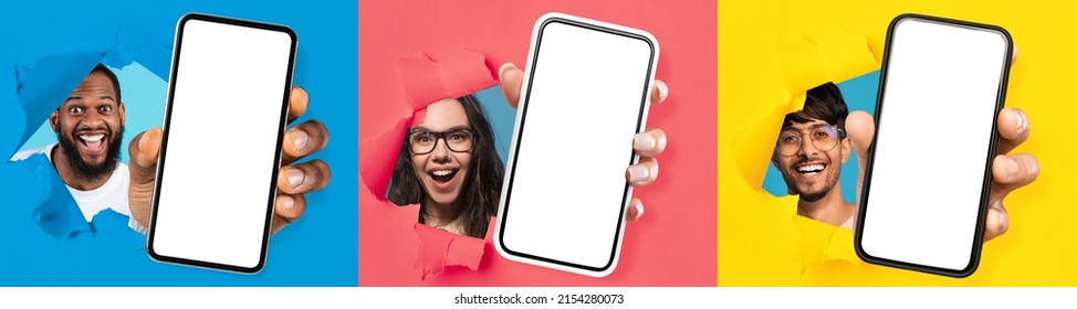 Wow, Great Offer. Three excited young diverse people holding 3 big cell phones with white blank screen in hand, showing to camera through torn paper holes. Gadgets with empty free copy space, banner