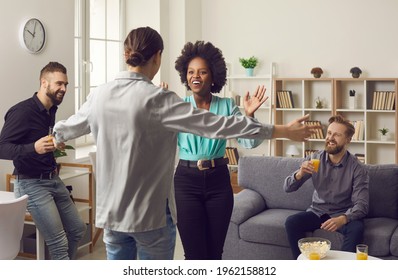 Wow, How You've Changed, Girl. Two Young Women Surprised And Happy To See Each Other. Excited Cheerful Female Friends Hug As They Meet At A Fun Reunion Party At Home