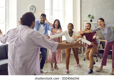 Wow, look who's back. Group of people are very happy to finally meet their friend who's been away and is back home again. Excited young man spreads arms wide open to hug his friends he missed so much
